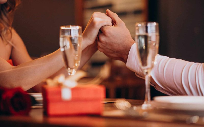 Couple holding hands on valentines evening in a restaurant